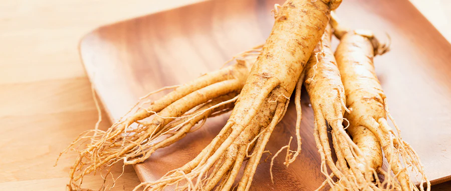 Siberian ginseng roots on a timber board