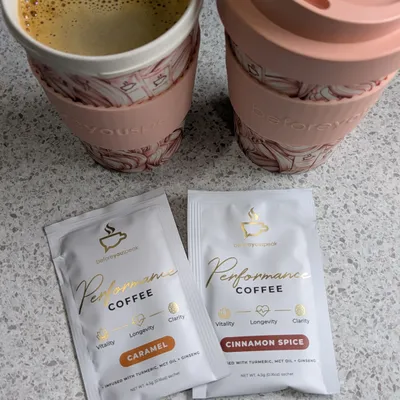 Customer-uploaded pink cups with Performance Coffee Caramel and Cinnamon Spice sachets