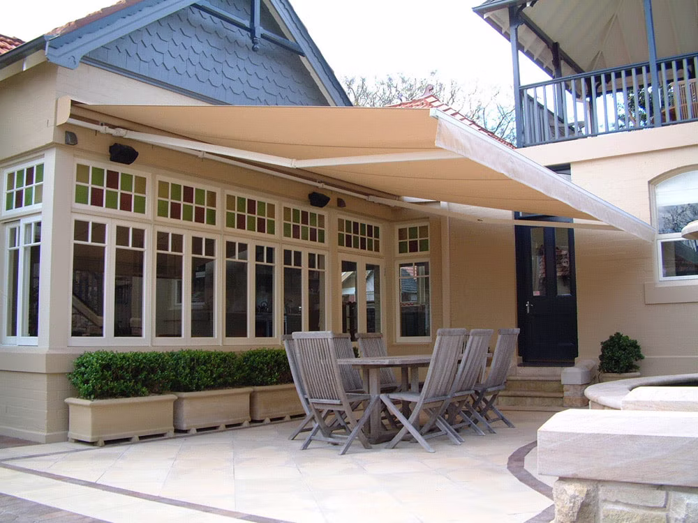 Folding arm awning extended over a residential patio