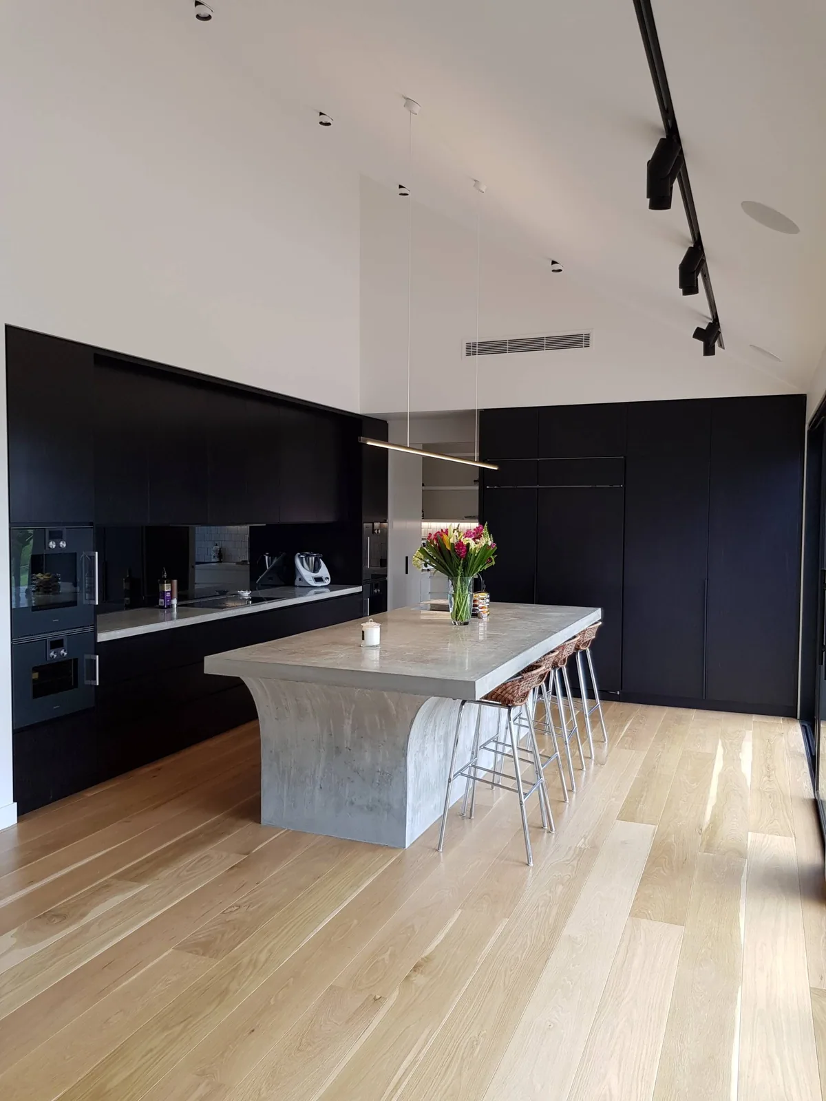 Black-stained kitchen cabinetry in one of our residential projects