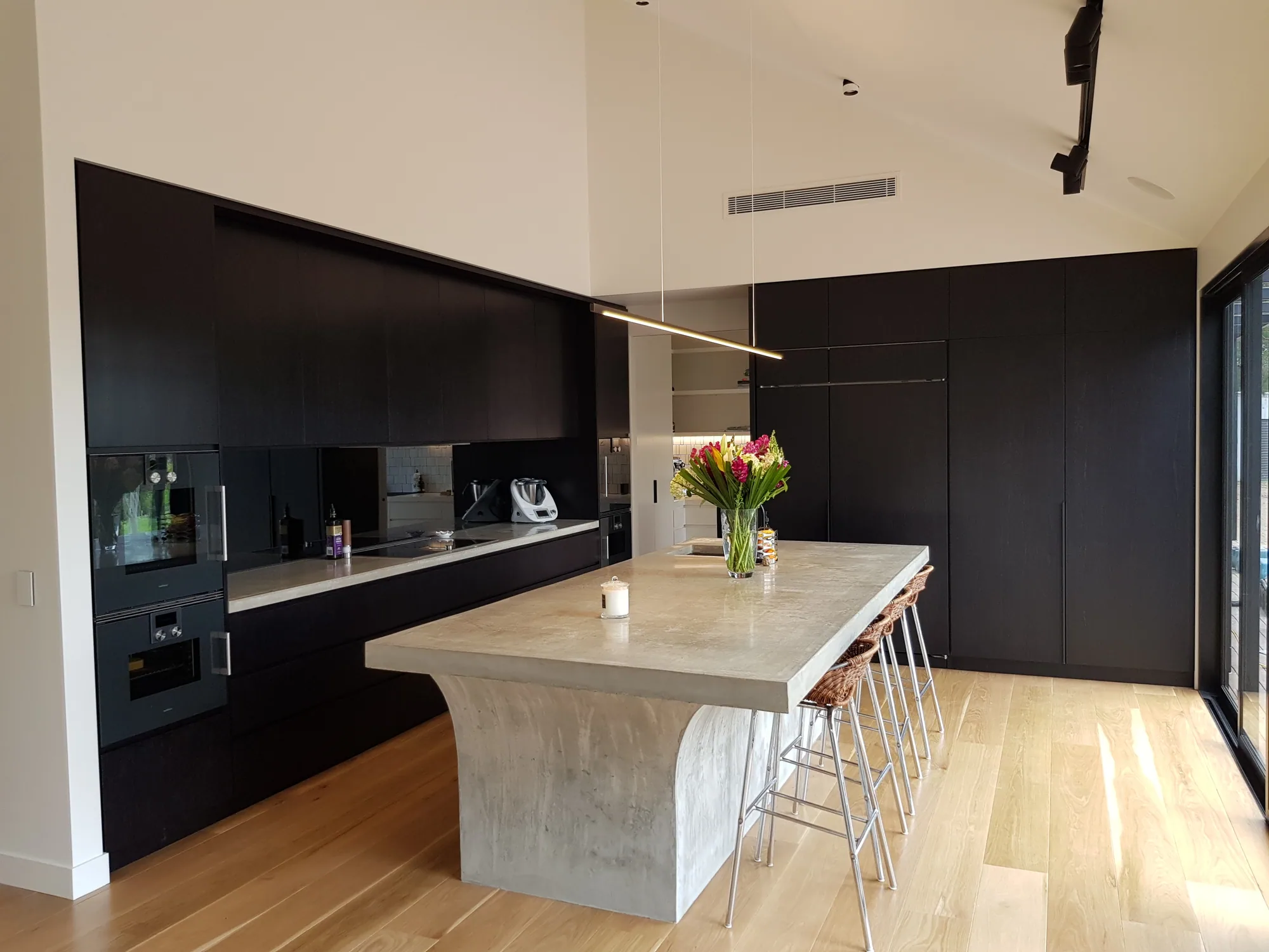 Black-stained kitchen cabinetry in one of our finished residential projects