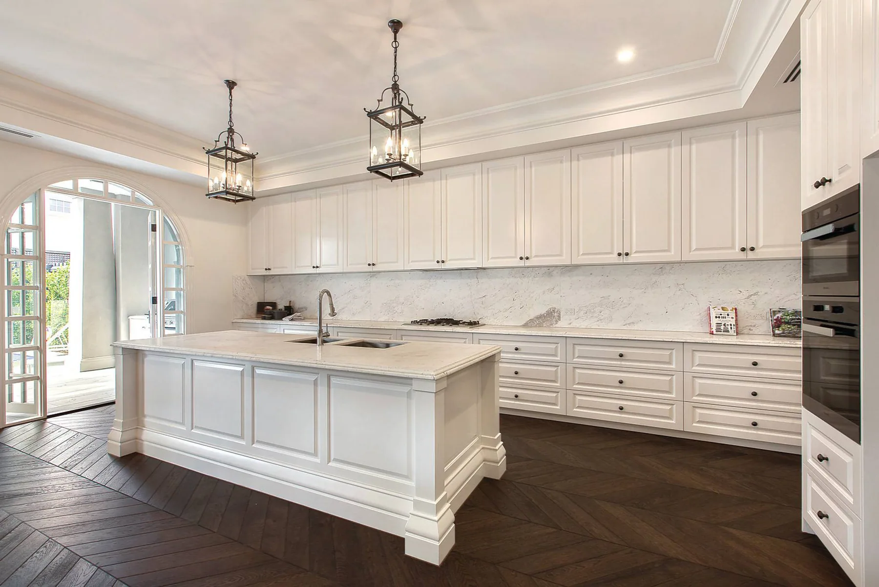 White moulded kitchen cabinetry in one of our finished residential projects