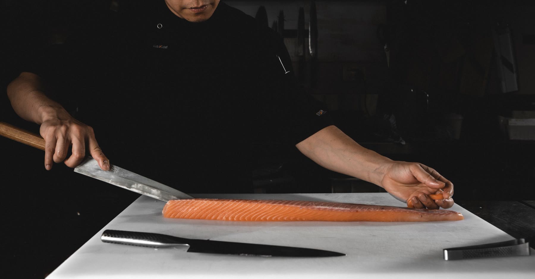 Our chef slicing a whole side of salmon