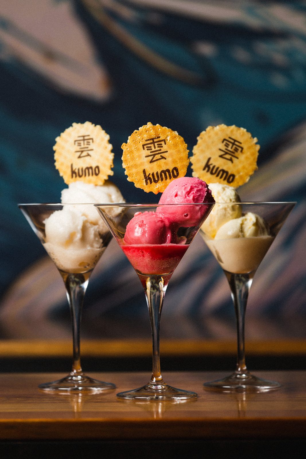 Three desserts served in coupe glasses