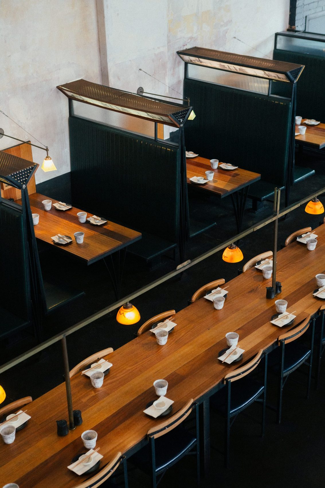 The long dining bar under its row of pendant lights