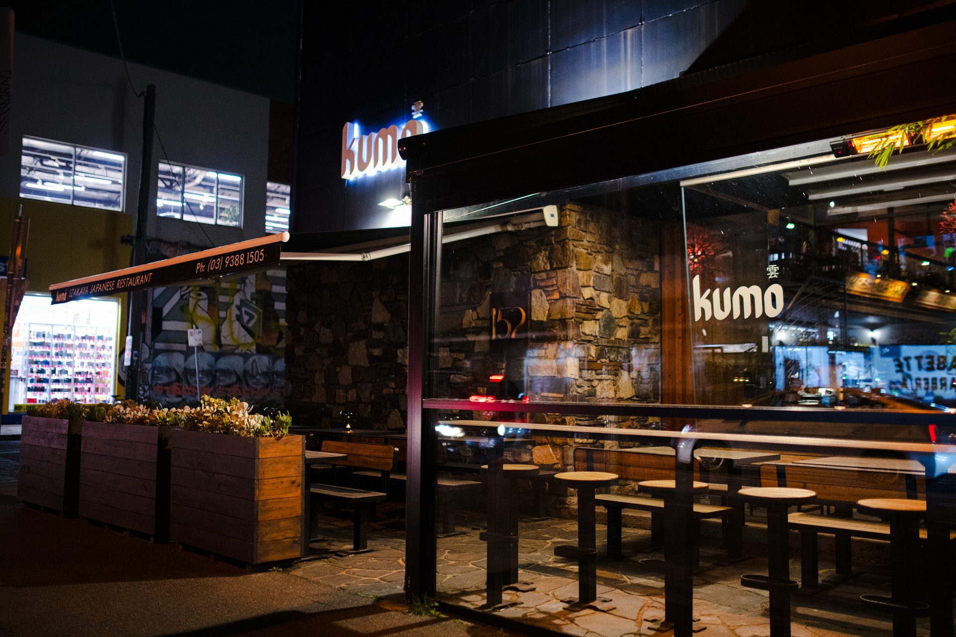 The Kumo Izakaya frontage on Lygon Street, lit up at night