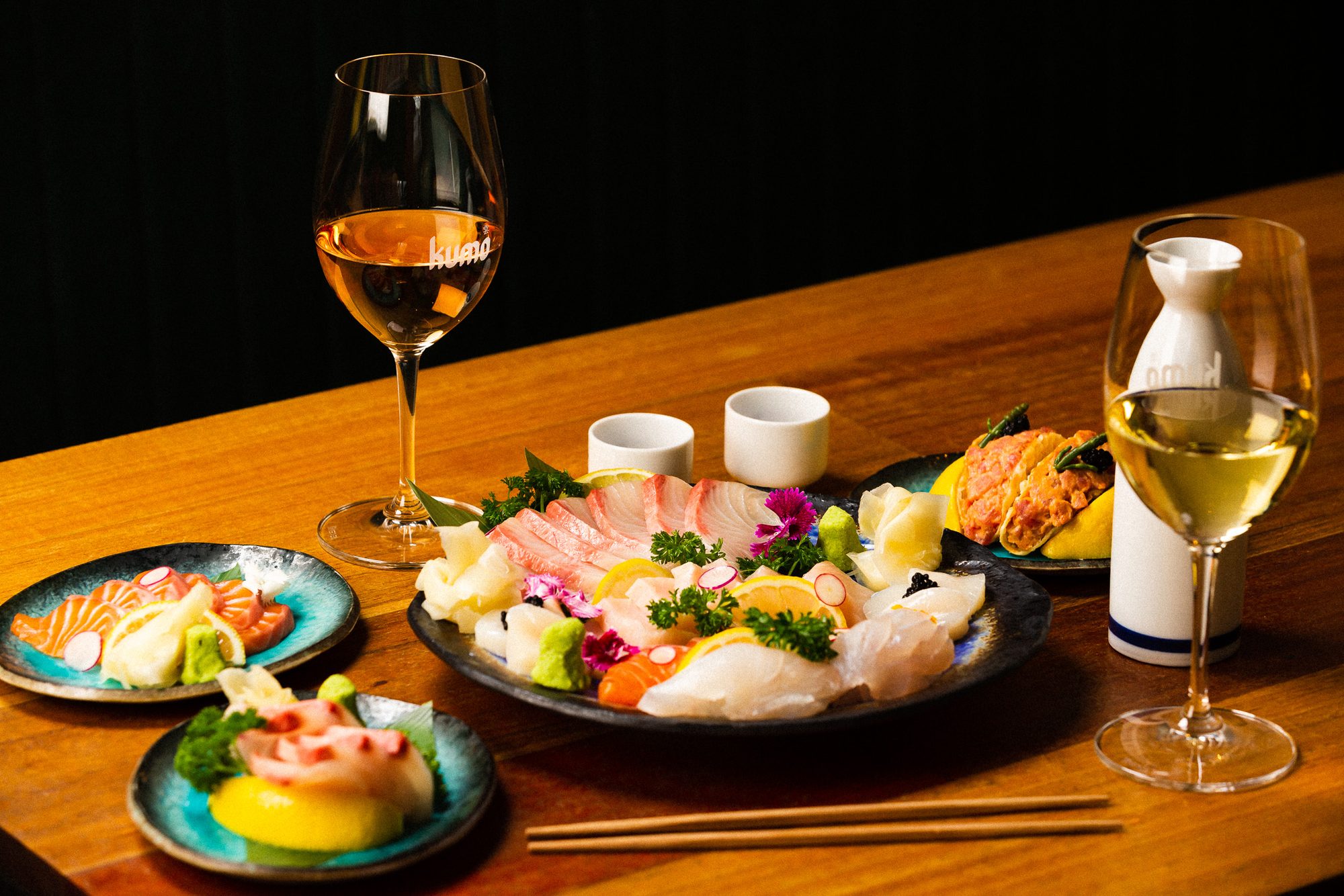 A sashimi platter served with wine and sake