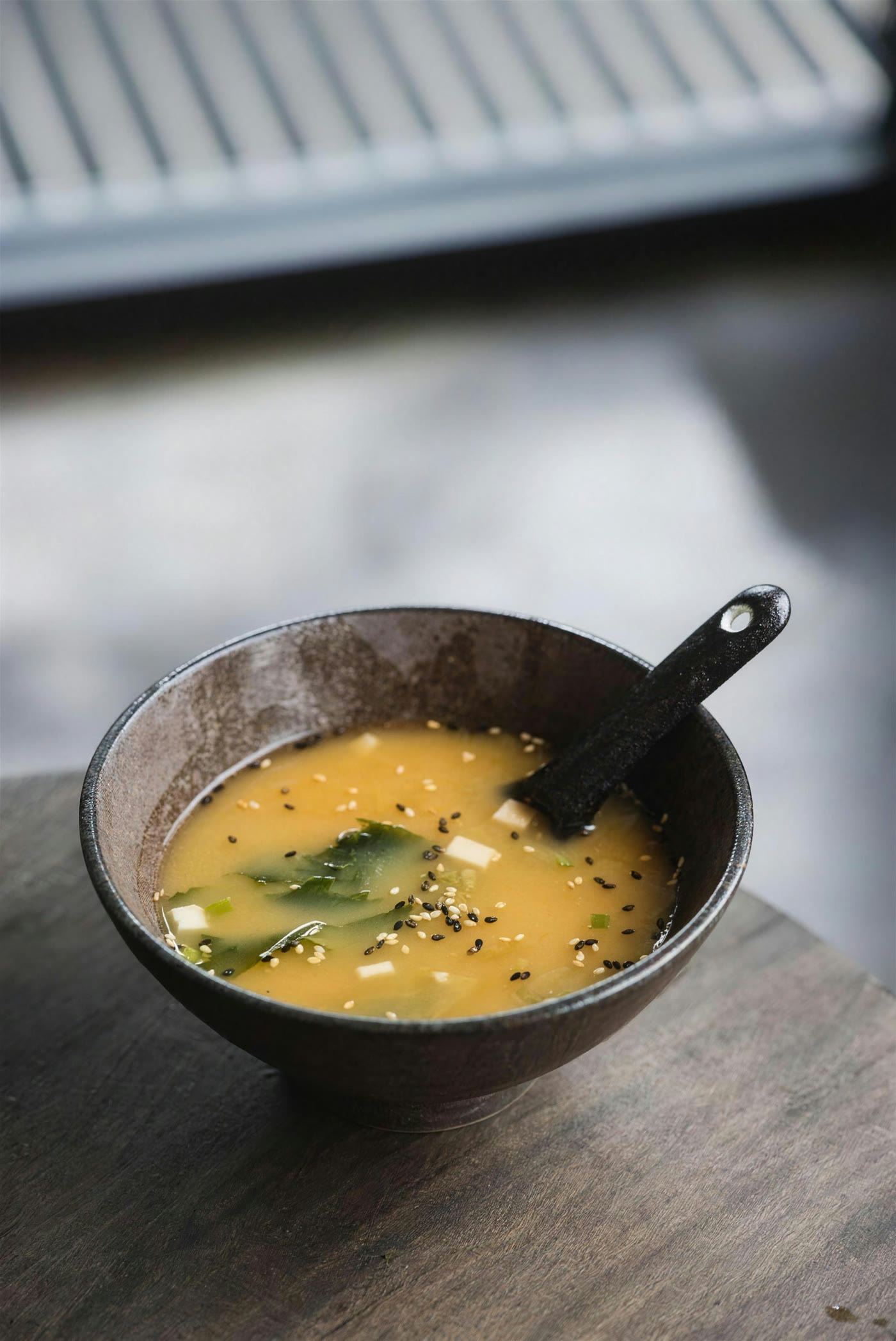 A bowl of miso soup on the counter